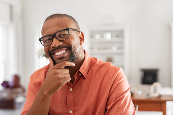 mature man wearing glasses flashing a clean smile