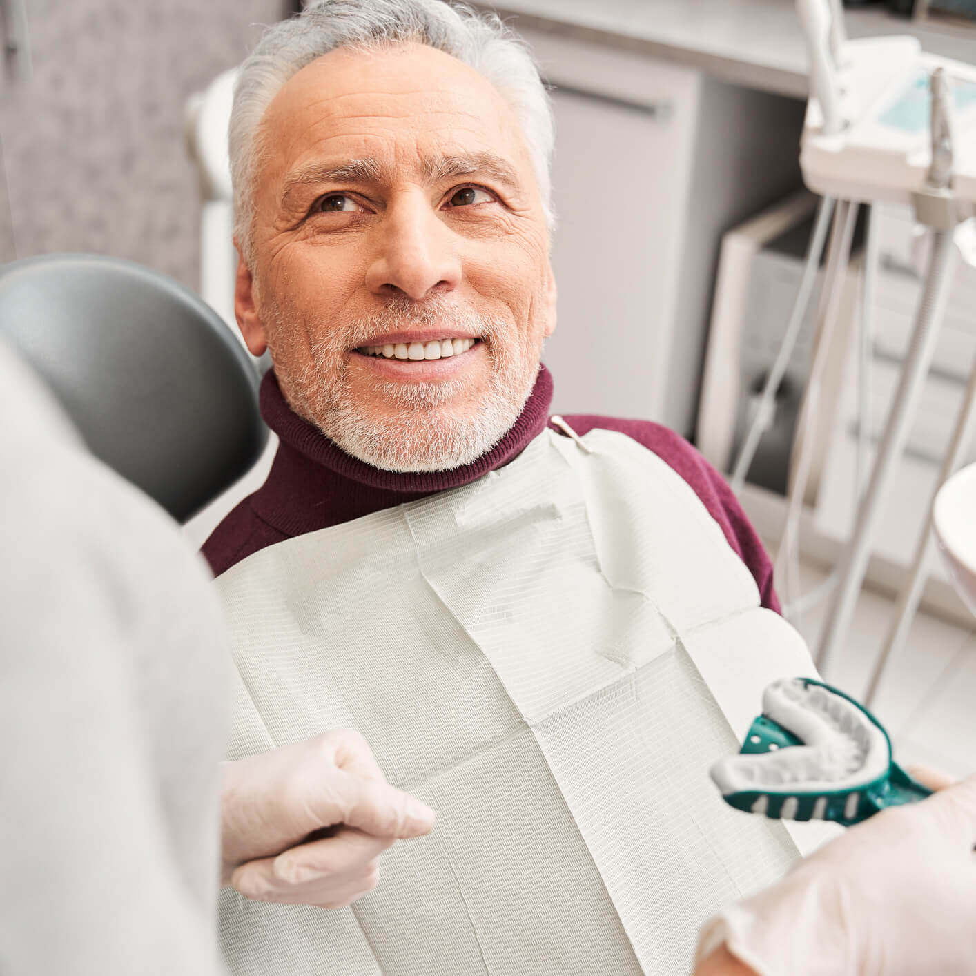 Patient is looking happy to get done his work done by dentist.