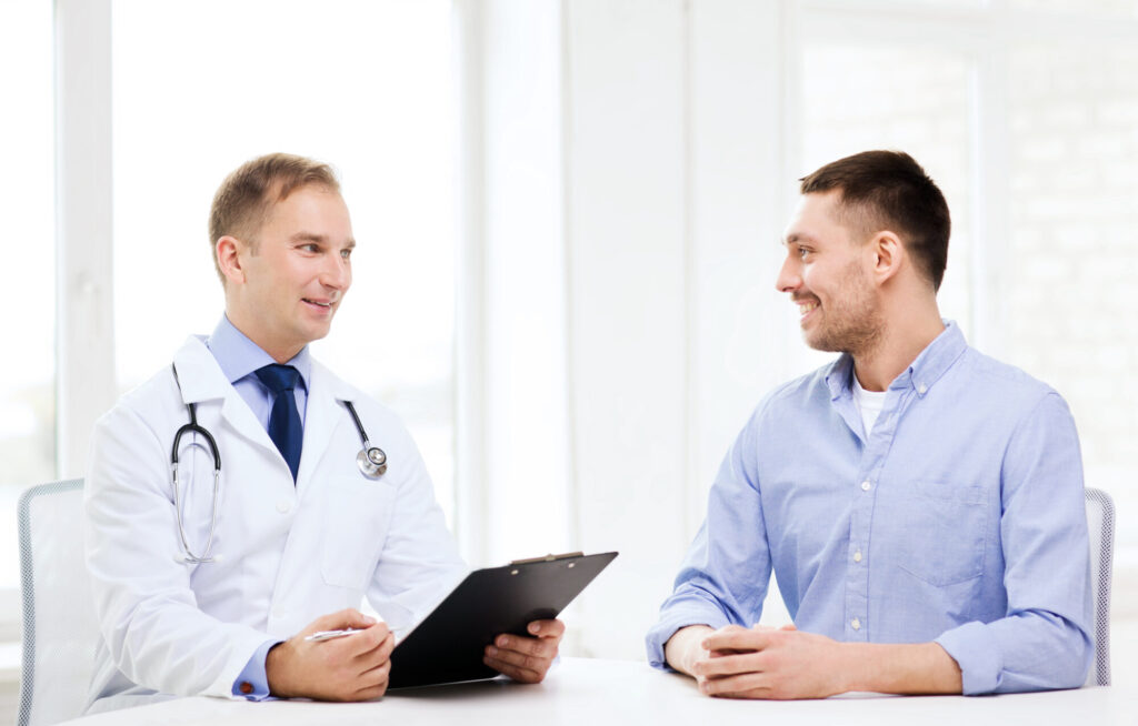 doctor with clipboard and patient in hospital