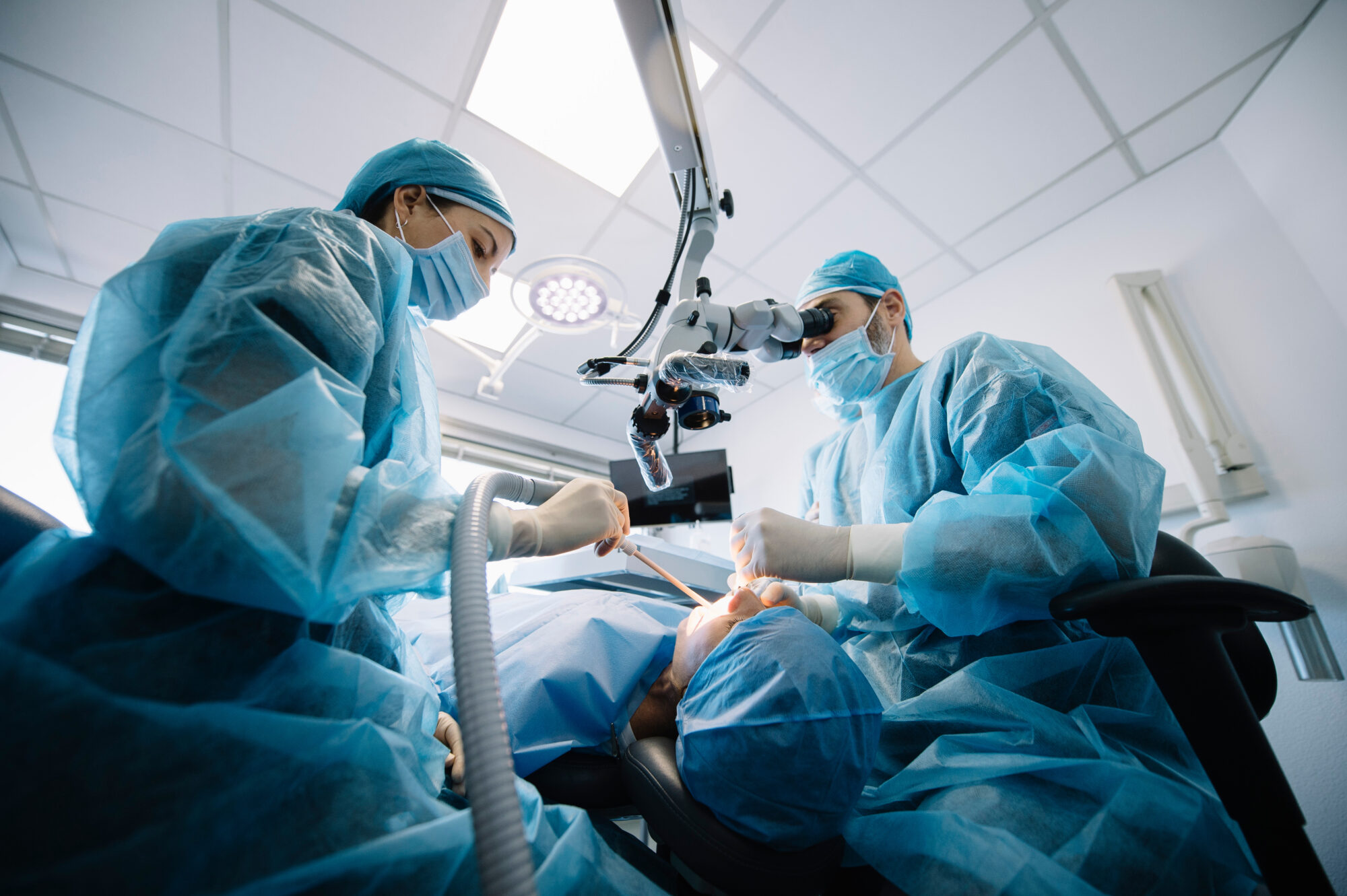 Dentist during a dental intervention with a patient. Dental clin